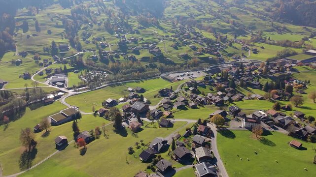 Aerial view of Grindelwald Grund railway station and the alpine village in autumn. Grindelwald, Canton of Bern, Switzerland.