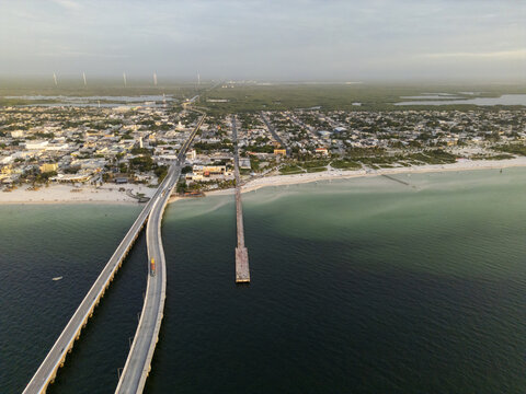 Aerial view of Puerto Progreso featuring the long pier extending into the Gulf of Mexico, the coastal bridge, and the urban layout of the town in Progreso, Yucatan, Mexico.