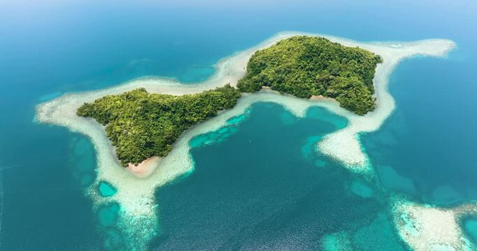 Aerial drone of tropical island and coral atoll with turquoise water. Seascape in the tropics. Borneo, Sabah, Malaysia.