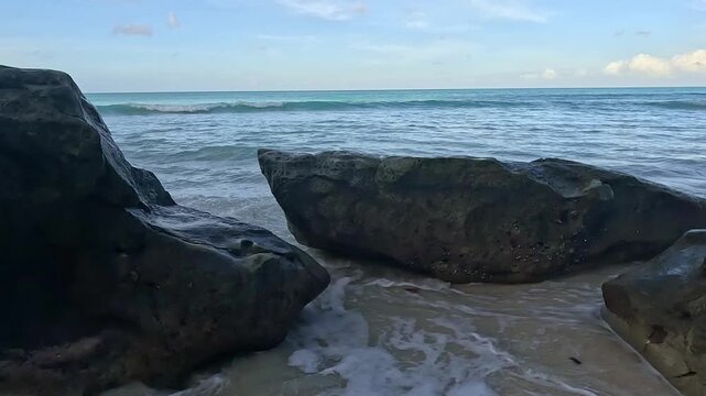 Waves crashing against dark volcanic rocks on Kalapathar Beach, Havelock Island, Andaman and Nicobar, IndiaWaves crashing against dark volcanic rocks on Kalapathar Beach, Havelock Island, Andaman and 
