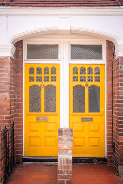 LONDON - bright yellow doors on period terraced house