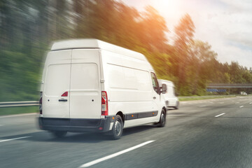 White modern delivery small shipment cargo courier van moving fast on motorway road to city urban suburb. Business distribution and logistics express service. Mini bus driving on highway on sunny day © Kyryl Gorlov