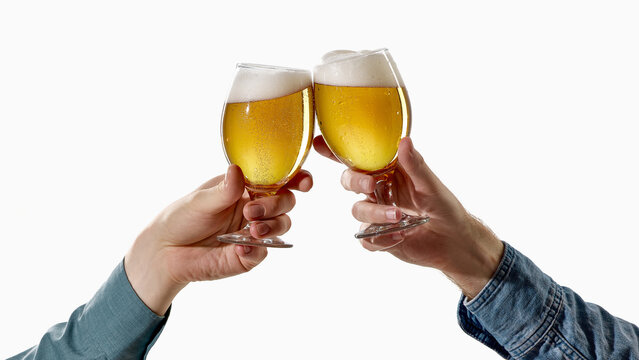 Two hands toasting with foamy beer glasses on white background. Concept of cheers, beer celebration, friendship, afterwork drinks, pub advertising, party poster and success toast.