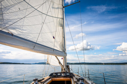 Sailing on a calm lake with a clear sky and gentle breeze in the afternoon sun