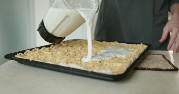 Caucasian man make potato pie. Single male is cooking at kitchen at home. 4K 10-bit