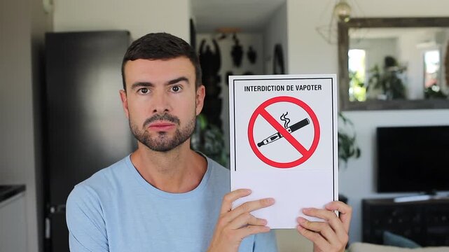 Man Holding French No Vaping Prohibition Sign