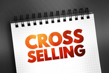 Fototapeta premium Cross Selling - action or practice of selling an additional product or service to an existing customer, text quote on notepad