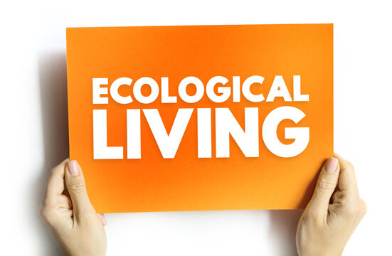 ECOLOGICAL LIVING text on card held by hands. Concept of sustainability, nature, and environment protection. Idea of green lifestyle, balance, and conscious human choices