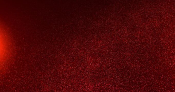 Warm red particle field with glowing dust scattered across a dark background. Abstract energy texture for cinematic, festive and design themes.