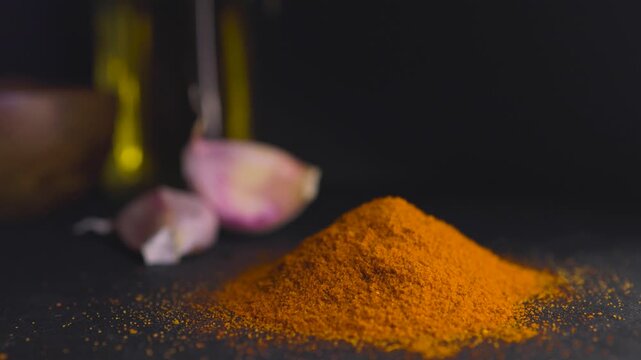 Horizontal video of red parika falling from above. Blurred background.Promotional graphic resource for spices and food.Concept of smoked spices and flavours.Spices and food promotion.
