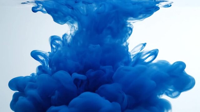 Deep blue ink cloud dissipating in clear water.