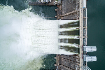 Obraz premium Aerial top down view of water discharge at hydroelectric power plant