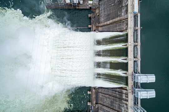 Aerial top down view of water discharge at hydroelectric power plant
