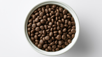 Fototapeta premium Bowl of dry dog food kibble viewed from above on a clean white background, representing pet nutrition and healthy canine feeding.