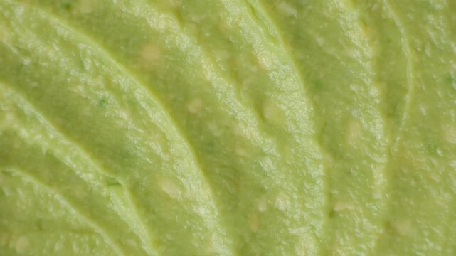 Abstract food background of fresh mashed avocado texture