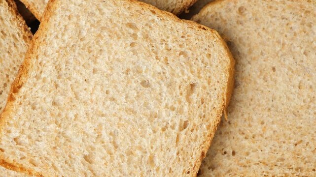 Top view of whole wheat toast bread slices rotating slowly.