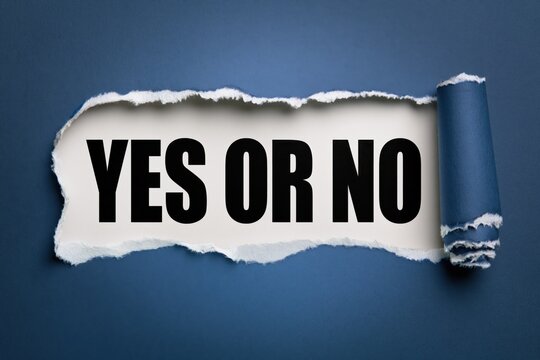 yes or no phrase written on white paper under torn blue paper