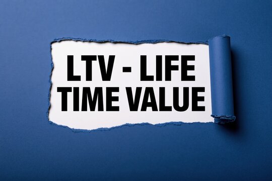 ltv - life time value phrase written on white paper under torn blue edge