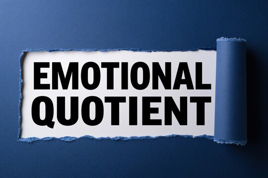 Emotional quotient text on white paper under torn dark blue paper