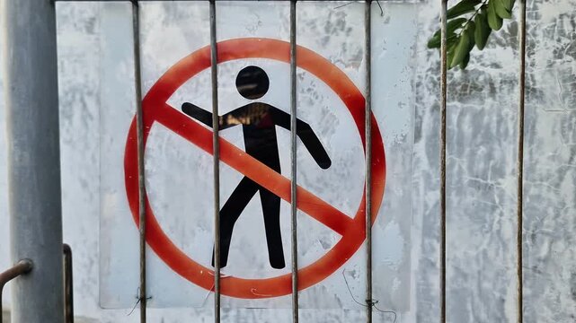 Prohibition Sign for Pedestrians on Wire Fence Restricting Access to Dangerous Construction Area