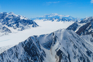 Naklejka premium Glacier and snow-covered mountains seen from flight to Mount Logan Base Camp in Kluane National Park, Yukon, Canada