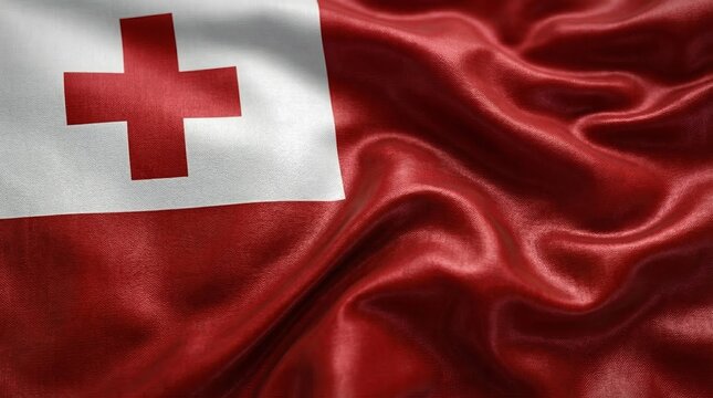 Vibrant national flag of Tonga waving with deep red fabric folds and a white canton