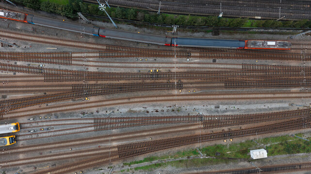 Top-Down View of Railway Tracks Converging at Major Train Station