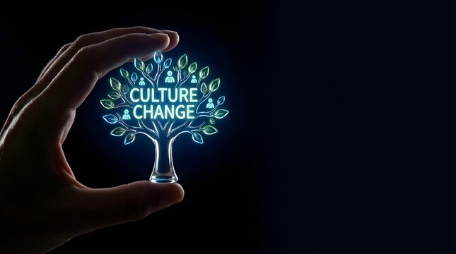 Human hand holding glowing tree symbolizing culture change