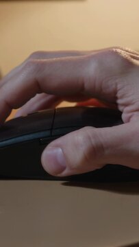 Vertical video: Index finger flexing, right hand clicking to control computer at desk, black mouse