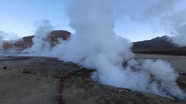 View of steam rising from the El Tatio geyser field at sunrise in the volcanic landscape of San Pedro de Atacama, Antofagasta, Chile.