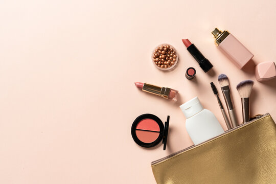 Cosmetic bag with brushes, lipstick, parfum, shadow.