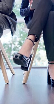 Legs, waiting and business people in office for job interview, vacancy or recruitment meeting. Queue, opportunity and corporate candidates in line for hiring or employment process in workplace.