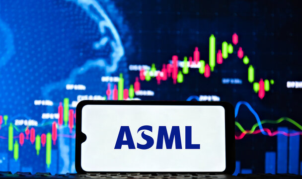 ASML Semiconductor Company Logo Displayed on Smartphone with Financial Stock Market Charts on Screen in the Background.