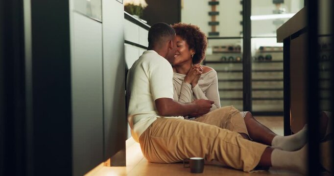 Kiss, pregnancy test and couple on floor in kitchen with positive results, bonding and good news. Happy, pregnant and black man with woman for celebration of family growth in marriage at home.