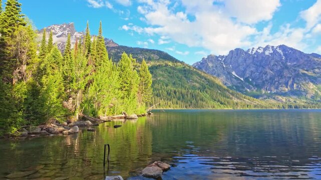 Majestic Teton mountains mirrored in the crystal clear waters of Jenny Lake at Grand Teton National Park