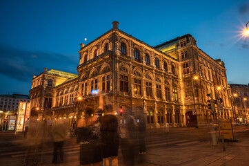Fototapeta premium Opera house lit during the evening. Evening view. The historic opera house is a symbol and landmark of the city of Vienna.