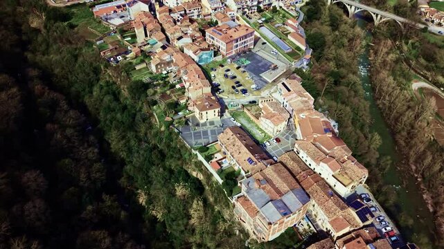 Drone descending over cliffside village of Castellfollit de la Roca in Catalonia