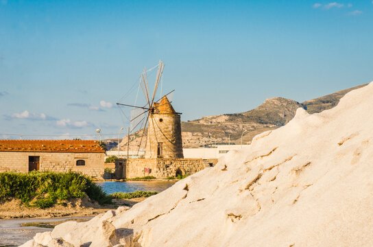 Trapani sea salt production view of old windmill at salt marches in Sicily, Italy	