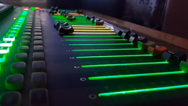 Audio mixer fader moving upward during broadcast production