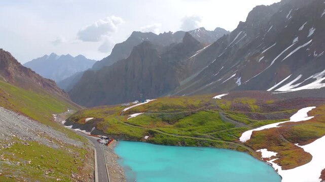 Aerial view of a winding mountain road snaking through high peaks and gorges; the beautiful scenery of the Duku Highway in Xinjiang, China.目