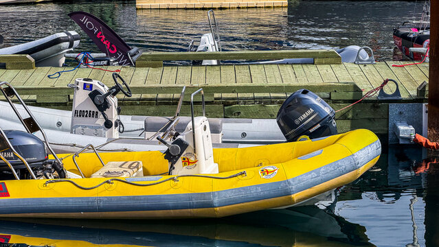 Boats docked in a marina with various engines and equipment visible