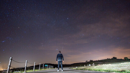 A white European man with his back turned, observing the star-filled night sky. Malpica do Tejo, Portugal. © Pedro Emanuel 