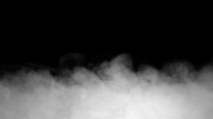 Fototapeta premium Realistic white fog isolated on black background with soft drifting mist, dense vapor texture and atmospheric smoke effect. Low-lying fog overlay ideal for photo compositing, cinematic scenes,