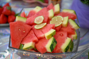 Sliced watermelon served as fresh summer fruit on a table. Seasonal food supports hydration, healthy eating and outdoor gatherings. © Liudmila