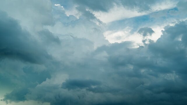 Gloomy storm clouds are gathering in the blue sky. A celestial timelapse of a cloudy sky. The beauty of the sky and nature.