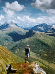 Man hiker standing alone on cliff edge travel in Norway climbing mountains healthy lifestyle active adventure summer vacations tour outdoor, globetrotter enjoying nature views freedom getaway harmony © EVERST