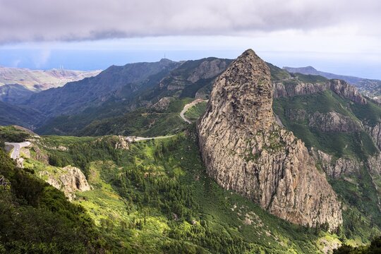 View of the Roque de Agando rock tower, one of La Gomera's landmarks, from the Mirador del Morro de Agando. During the day, sun and clouds. Monumento Natural de Los Roques, La Gomera, Canary Islands, Spain