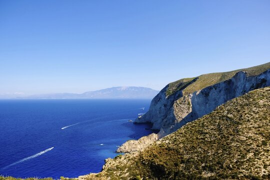 The view from the cliff access to Navagio Bay in Zakynthos, Greece, offers one of the most famous, breathtaking, and photographed panoramas in the world