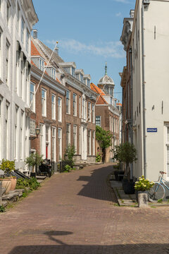 Middelburg, Netherlands. Narrow historic street with traditional Dutch houses and church dome in background