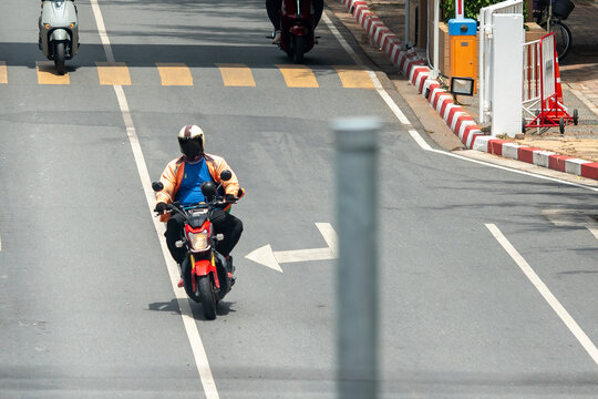 Motorbike rider on city street during daytime